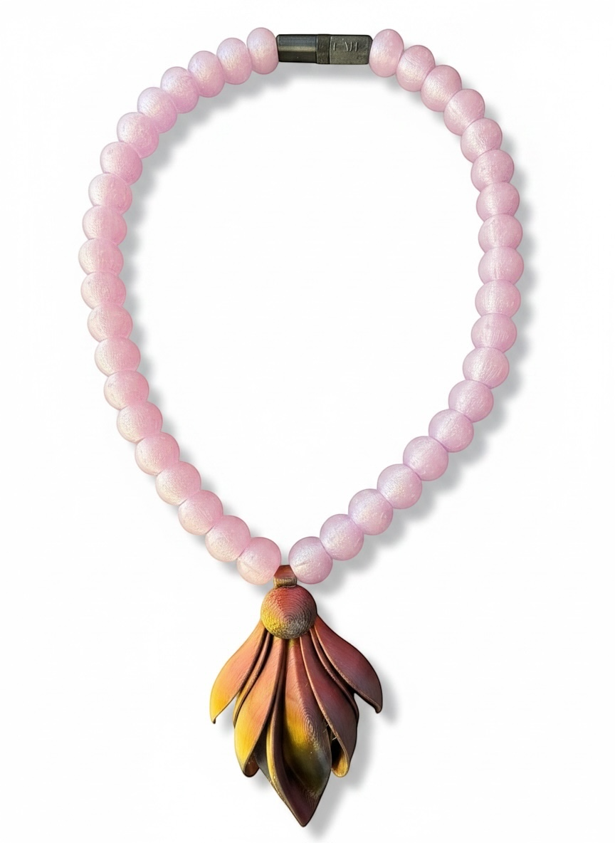 Necklace with pink beads and a colorful leaf-shaped pendant on a white background