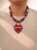 Woman wearing Latina Power sacred heart necklace, full pendant and beaded collar view in natural light