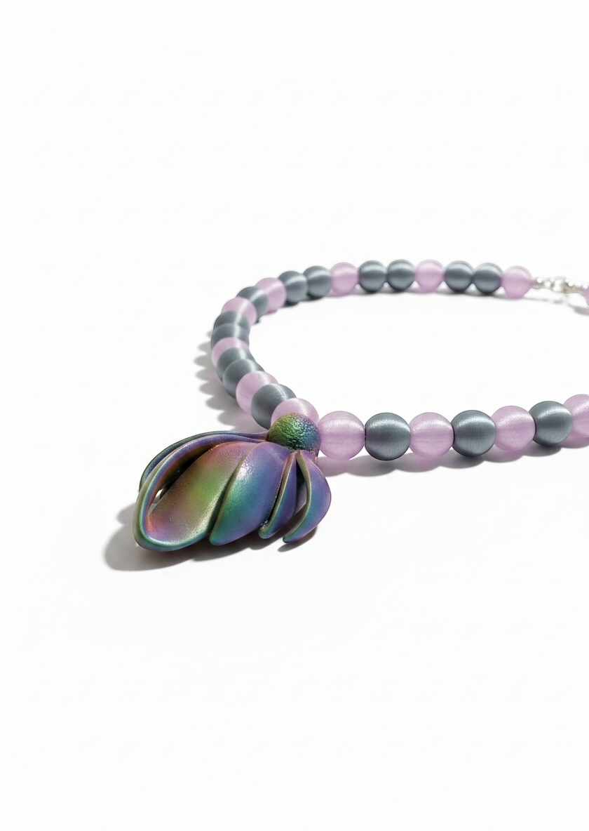 Beaded bracelet with a colorful shell charm on a white background